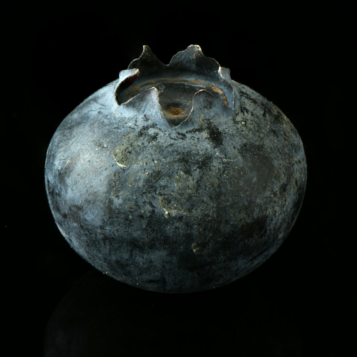 a blue vase sitting on top of a black table